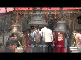 Hindu devotees ringing the temple bells at Naina Devi Temple