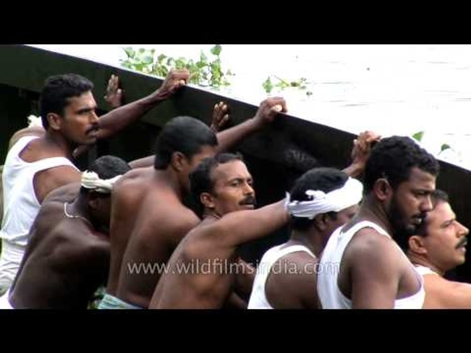 Local men parking the snake boat in Punnamada Lake, Kerala