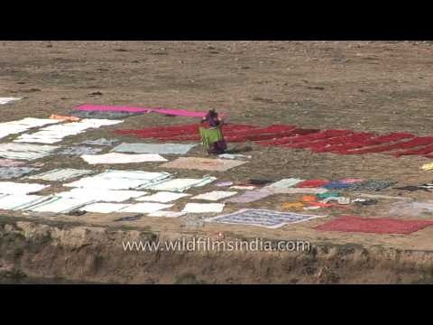 Women drying clothes on the banks of the sacred Ganges