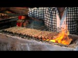 Time lapse of kebabs cooking on streetside BBQ