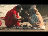 Hindu pilgrims come to pray on the sacred ghats of Varanasi