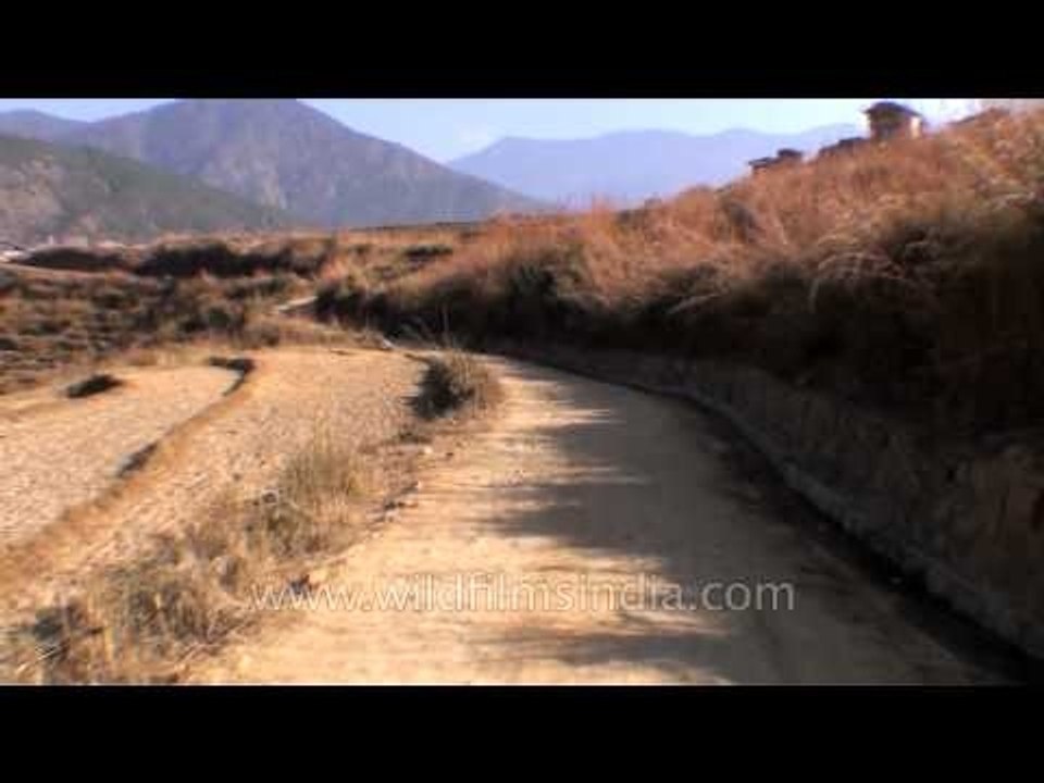 Driving on rough village road to Chime Lhakhang