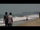Tourists enjoy the surf at Fort Cochin Beach