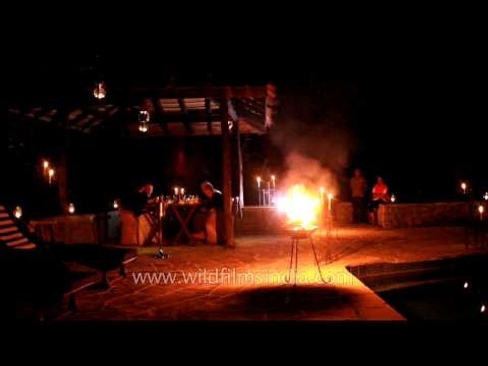 Visitors dining at swimming pool area, Kanha Earth Lodge