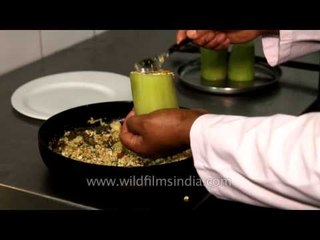 Chef preparing a delicious dish at Kanha Earth Lodge