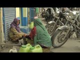 Water shortage in India: Woman collecting water from roadside tap