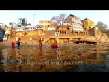 Devotee taking holy dip in the river Ganga