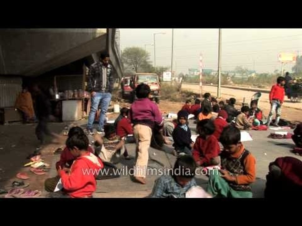 Children attending a free school, run under a metro bridge