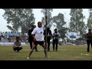 Amazing test of dental strength: A man lifts a bicycle on an iron pole