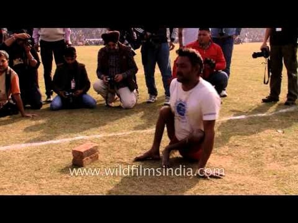 Physically challenged man lifting his weight on a bottle