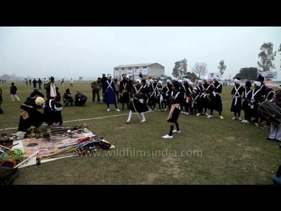 Young member of Nihang Sikh performing martial arts