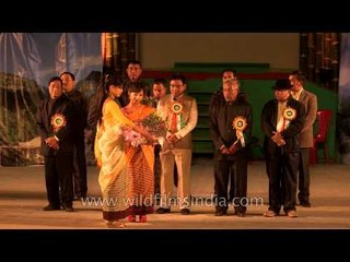 Presenting cocoon roses to the guest at Sangai festival