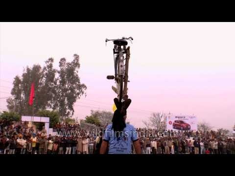 Man lifting cycle with his teeth: Kila Raipur Olympics
