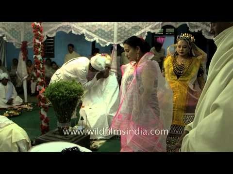 Manipuri bride showering flowers on groom