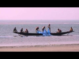 Hauling the fishing net in the boat near the Bakkhali beach