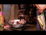 Local fish vendor collecting fishes to sell at the market