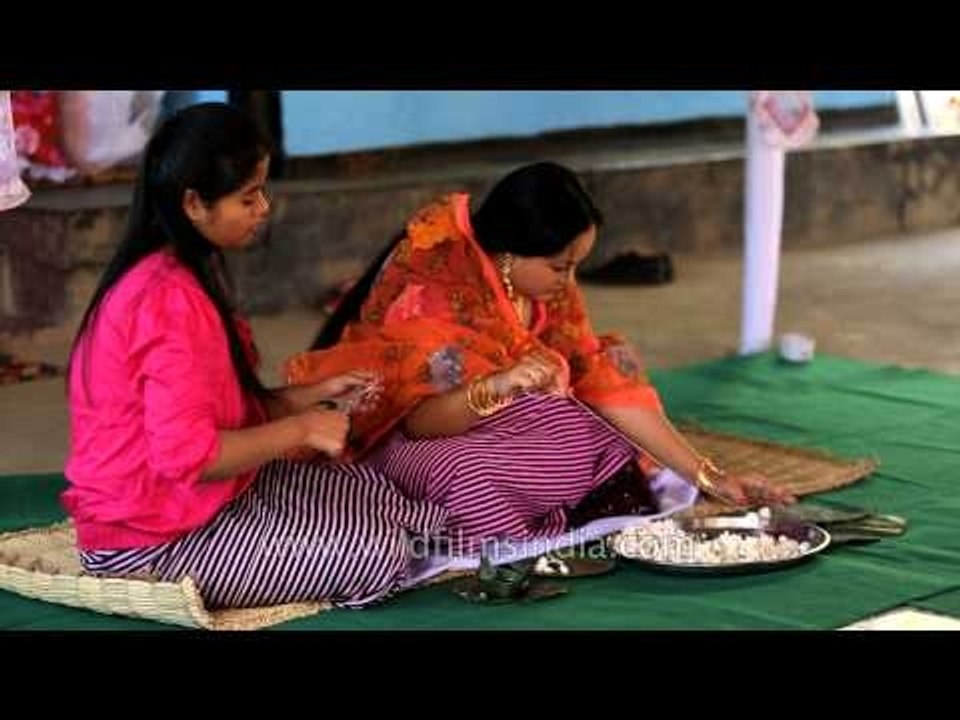 Manipuri bride makes garland for wedding