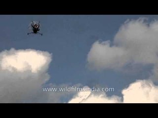 Paramotor flying in the blue sky