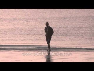 People walking on the eastern banks of the Bay of Bengal