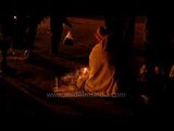 Hindu devotee offering prayers at night: Gangasagar mela