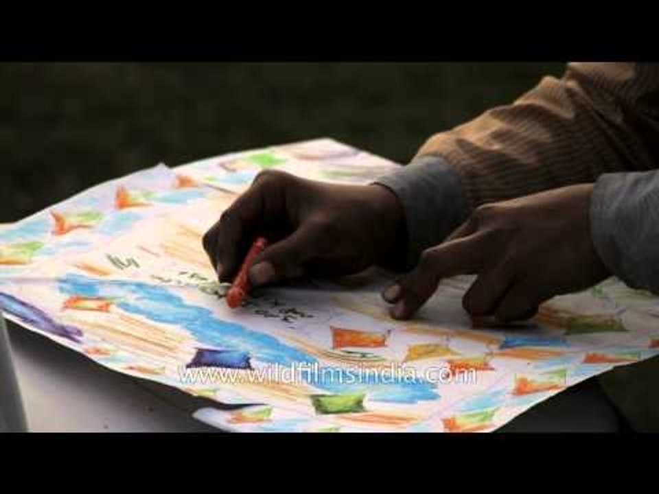 Children coloring their kites during the Kite Painting Competition