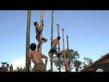 Naga youths climbing a vertical bamboo pole at Hornbill Festival