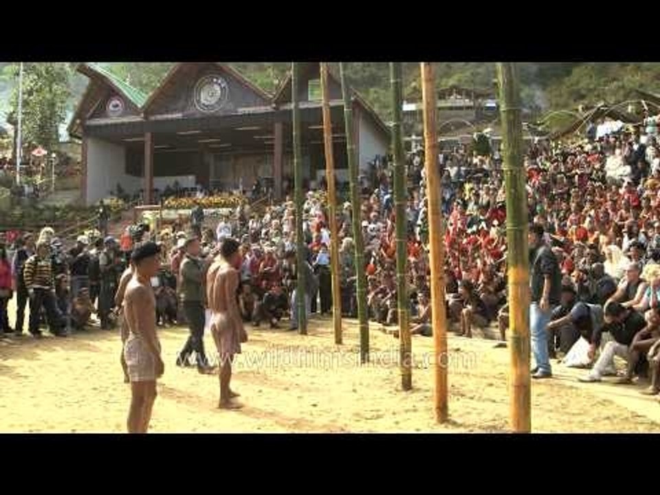 Naga youths climbing the pork greased pole during a competition