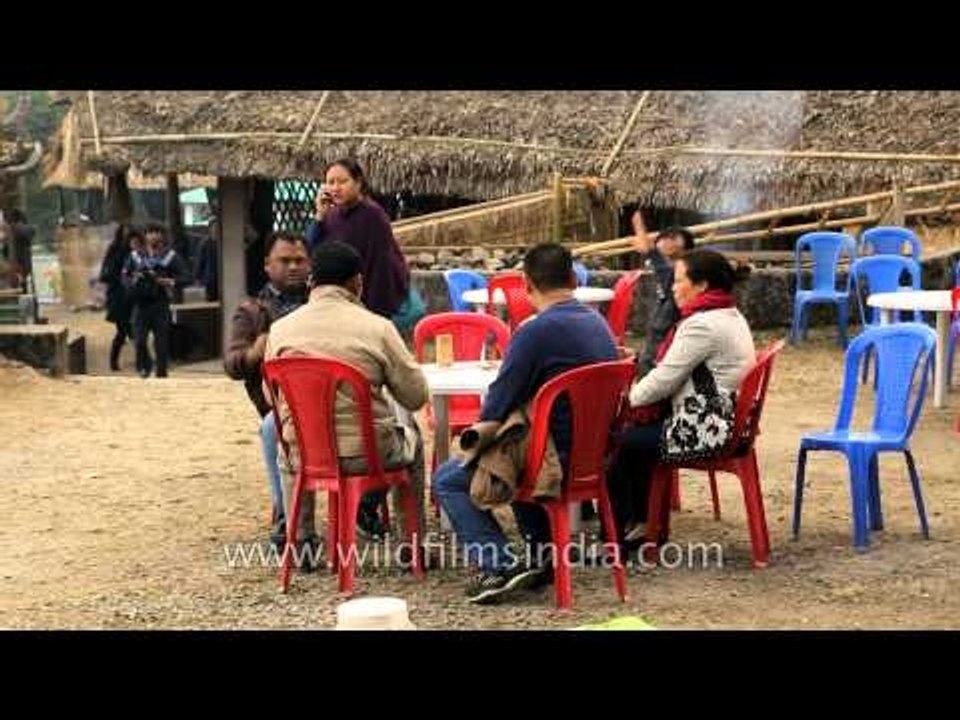 Visitors enjoying the local rice beer at Sangtam morung