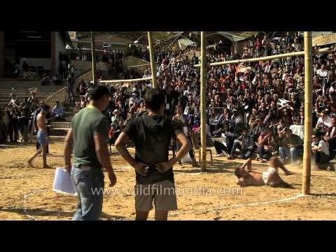 Naga boy kicks hard and falls back on his head at meat-kicking competition