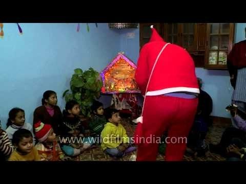 Santa distributing sweets to the poor chidren