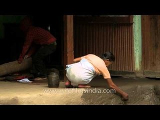 Manipuri woman cleaning house in the morning