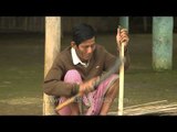 Manipuri rural craftsmen cutting bamboo