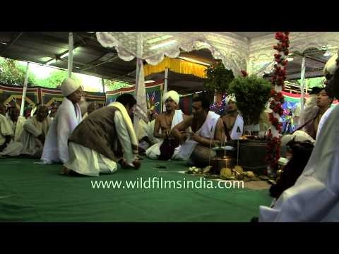 Male invitees of Manipuri wedding giving tips to Sankirtan singers