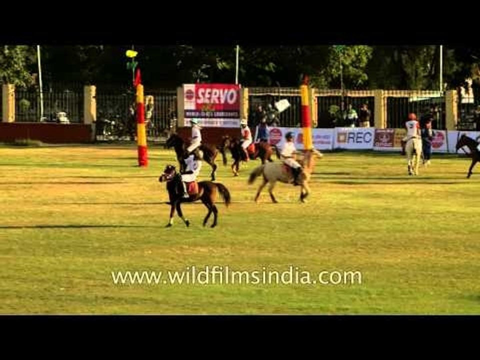 Skilled polo players competing for a strike