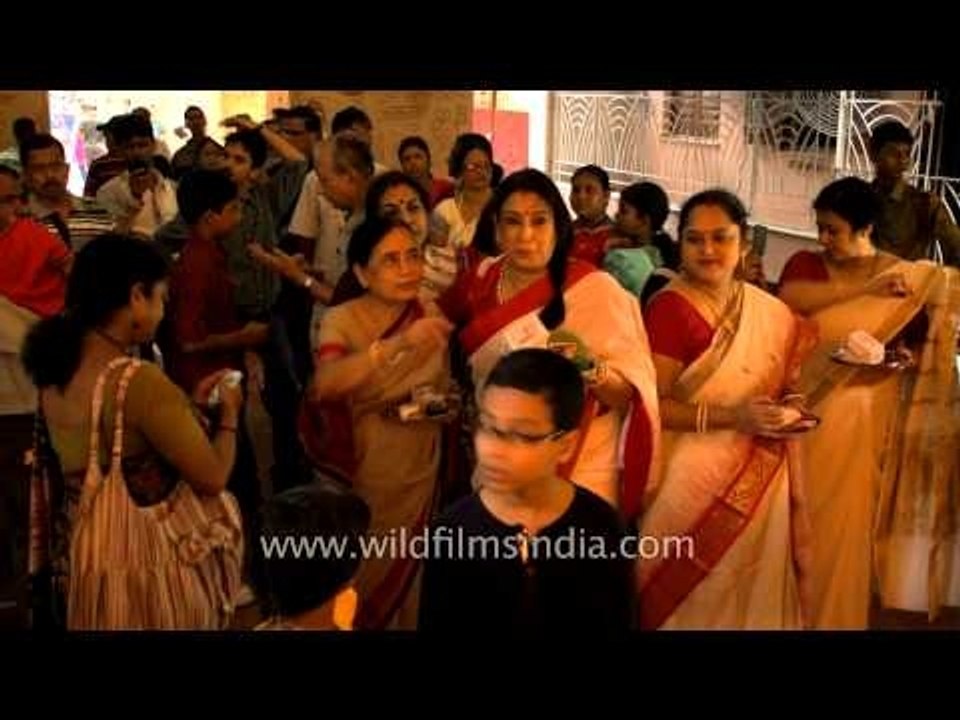 Bengali women wait for their turn to get blessings from Goddess Durga in Kolkata