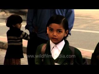 Group of school children waiting for bus