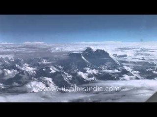 Aerial view over clouds, looking to Everest or Chomolongma