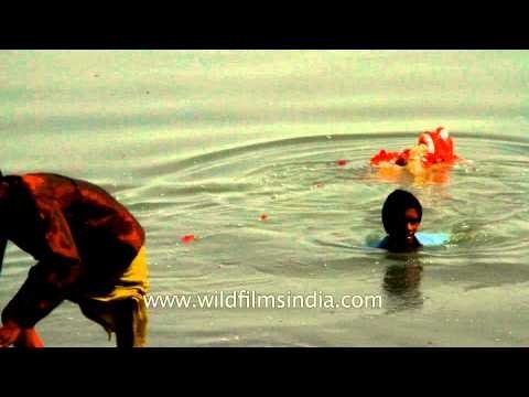 Idol of Lord Ganesh being immersed into the water