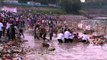Devotees submerging an idol of Hindu goddess Durga in the river Yamuna