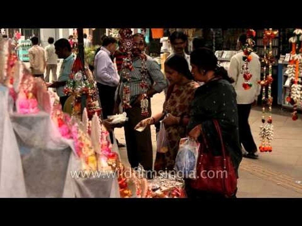 People buying idols of deities at a roadside stall in New Delhi on the eve of Diwali