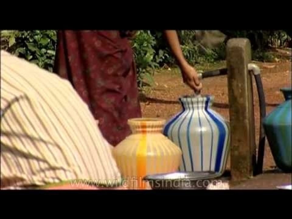 People queue for water in one of the wettest pl...