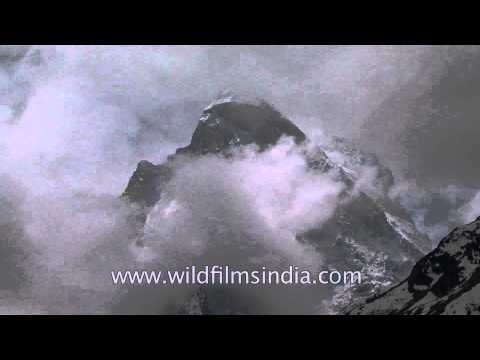 Clouds engulfing a snow clad Himalayan peak at Goumukh