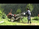 Bhutanese farmer moving a power tiller in Bumthang District pof Bhutan