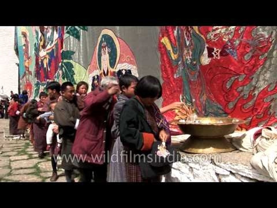 Lines of people waiting to touch the thangka during the Tsechu festival in Bhutan