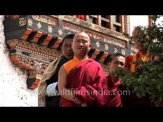 Bhutanese people in their traditional attire at a ceremony during the Tsechu festival