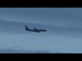 Airplane flying over Marina beach, towards Chennai airport