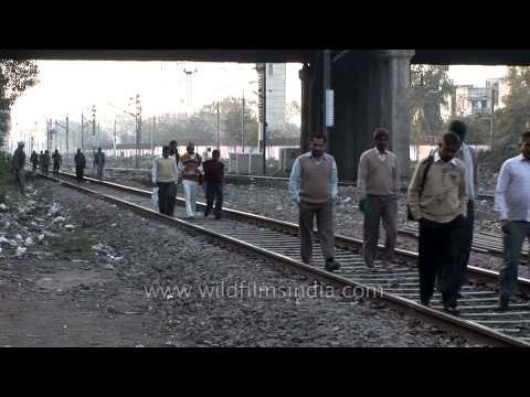 Pedestrians walking on railway tralks