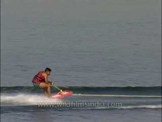 Boy falls in water while learning to water ski