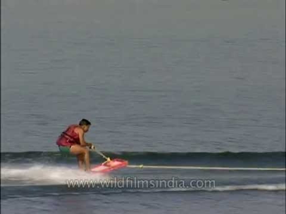 Boy falls in water while learning to water ski