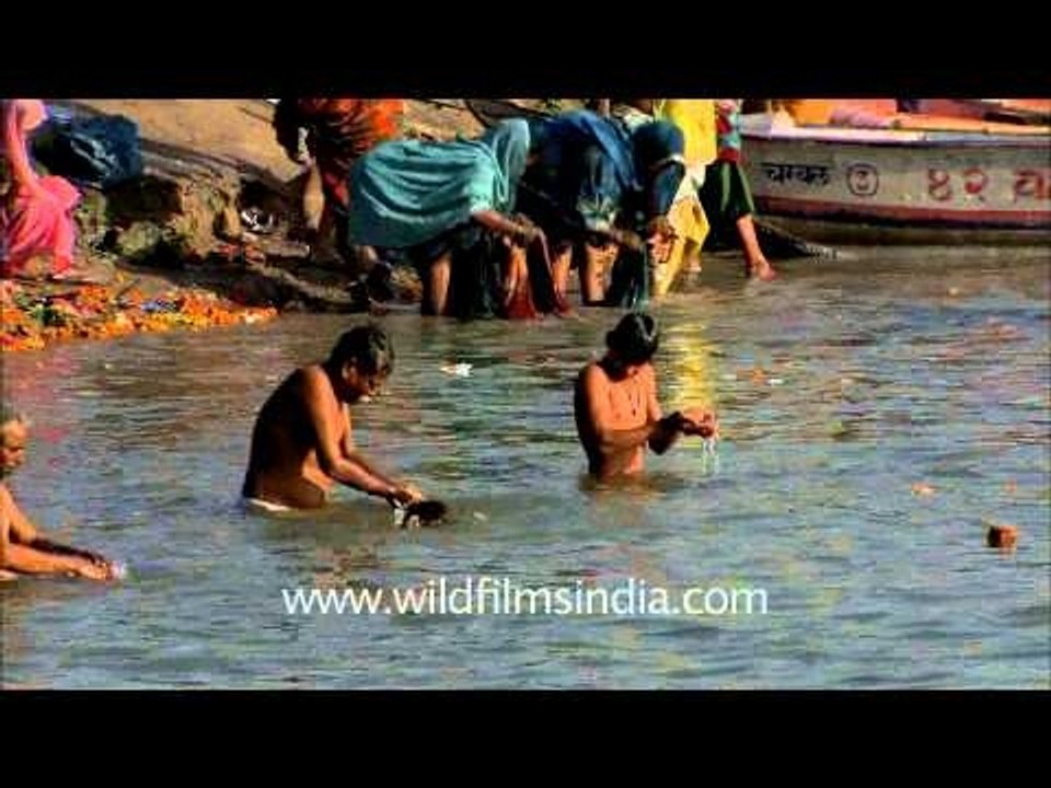 Devotees washing away their sins at holy ganga during Maha Kumbh